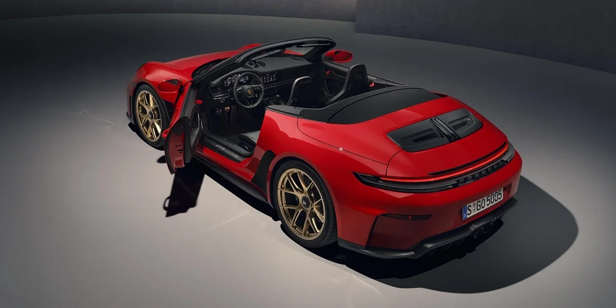 Rear three-quarter view of red Porsche 911 GT3 RS Cabriolet with driver door open.